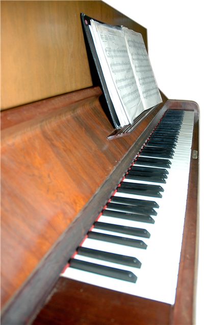 Old Piano with Sheet Music Notes
